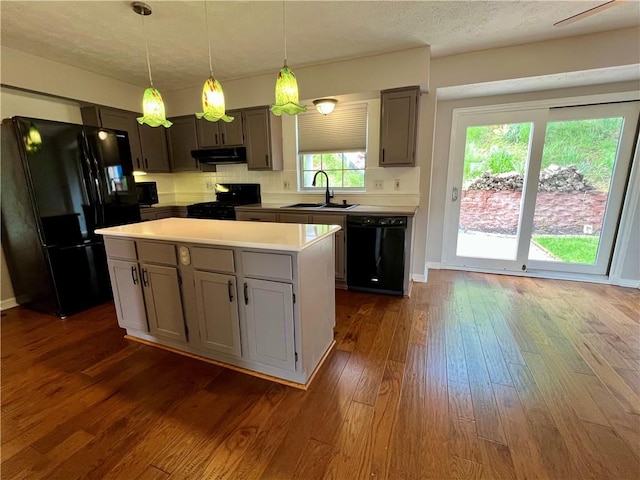 758 Venango Ave, Shaler, PA 15209 - kitchen with black appliances, a sink, under cabinet range hood, dark wood finished floors, and light countertops