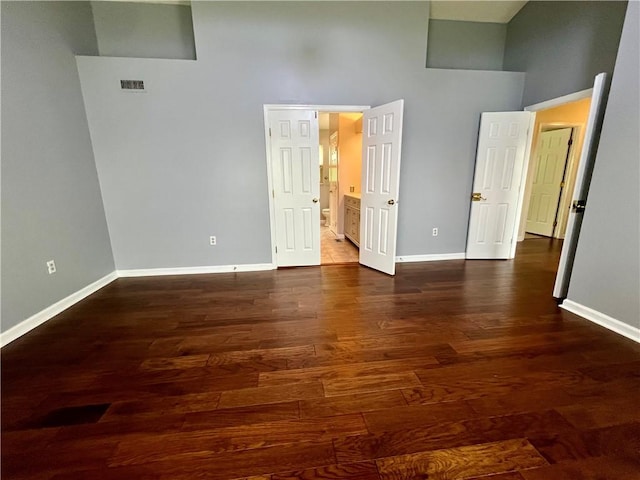 758 Venango Ave, Shaler, PA 15209 - unfurnished bedroom with a towering ceiling, baseboards, dark wood-style floors, and ensuite bath