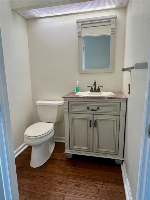 758 Venango Ave, Shaler, PA 15209 - bathroom with toilet, vanity, wood finished floors, and baseboards