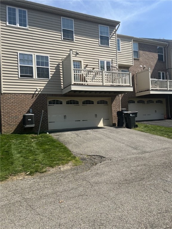 411 Fairgate, Pine Twp Nal, PA 15090 - back of house with a garage, brick siding, asphalt driveway, and central AC
