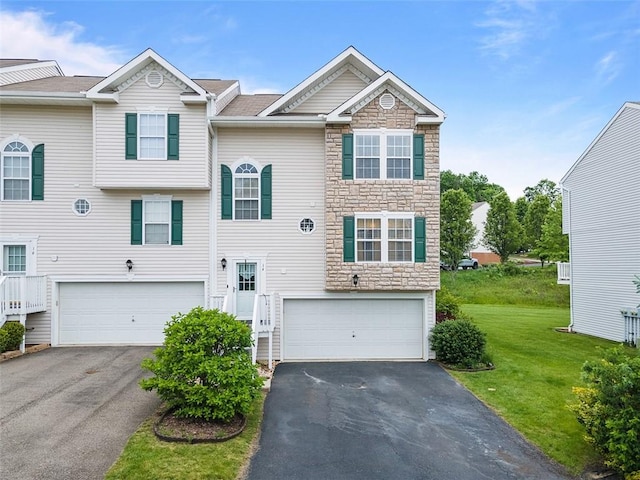 14 Cinque Terra Pl, Finleyville, PA 15332 - view of front facade featuring stone siding, an attached garage, asphalt driveway, and a front lawn