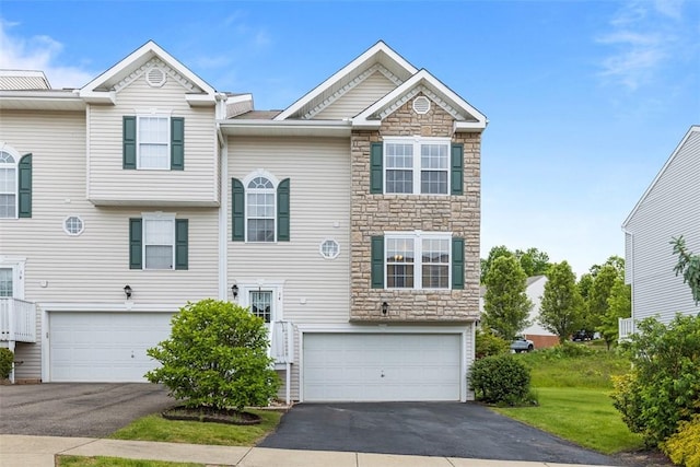 14 Cinque Terra Pl, Finleyville, PA 15332 - view of front of house with stone siding, an attached garage, and driveway