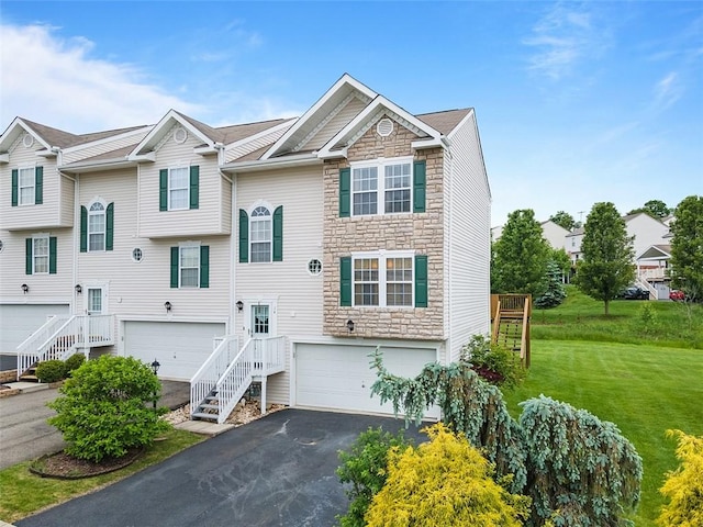14 Cinque Terra Pl, Finleyville, PA 15332 - view of front of house with stone siding, a garage, driveway, and a front lawn