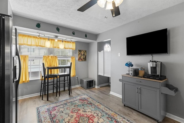 14 Cinque Terra Pl, Finleyville, PA 15332 - living room featuring a textured ceiling, light wood finished floors, ceiling fan, and baseboards