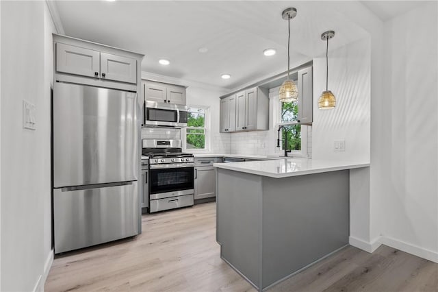 36 W Bellecrest, Brentwood, PA 15227 - kitchen with stainless steel appliances, gray cabinets, a peninsula, tasteful backsplash, and light wood finished floors