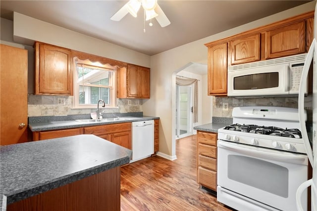 2501 Middletown Rd, Ingram, PA 15205 - kitchen with white appliances, dark countertops, backsplash, and wood finished floors