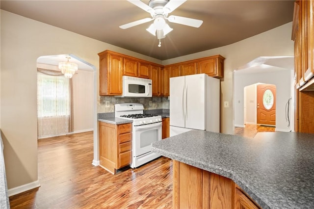 2501 Middletown Rd, Ingram, PA 15205 - kitchen featuring white appliances, tasteful backsplash, a chandelier, light wood-style flooring, and ceiling fan