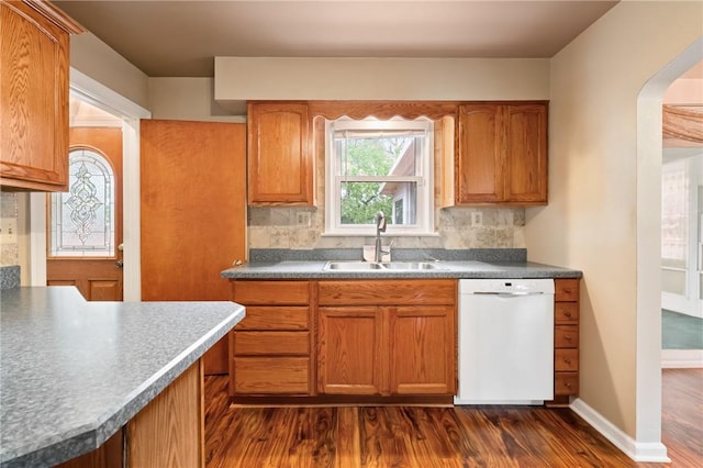 2501 Middletown Rd, Ingram, PA 15205 - kitchen featuring dishwasher, a sink, dark wood-style floors, backsplash, and arched walkways