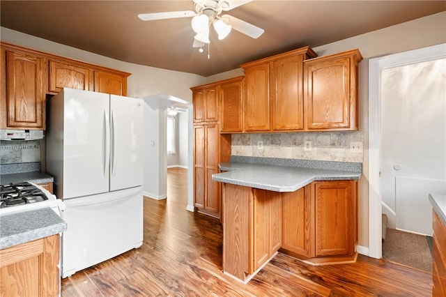 2501 Middletown Rd, Ingram, PA 15205 - kitchen featuring freestanding refrigerator, a ceiling fan, tasteful backsplash, and wood finished floors
