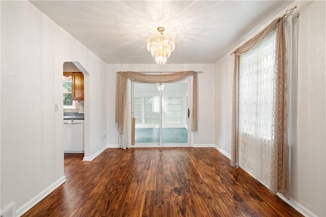 2501 Middletown Rd, Ingram, PA 15205 - unfurnished dining area with dark wood-style flooring, a chandelier, arched walkways, and baseboards