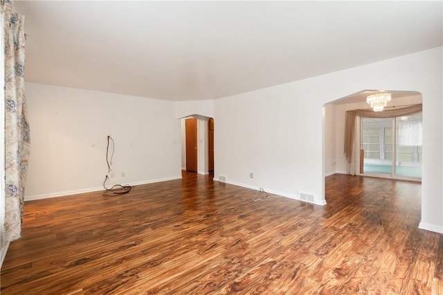 2501 Middletown Rd, Ingram, PA 15205 - unfurnished room featuring wood finished floors, arched walkways, baseboards, and a chandelier