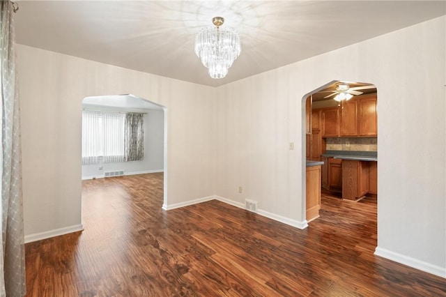 2501 Middletown Rd, Ingram, PA 15205 - empty room with arched walkways, dark wood-style floors, and baseboards