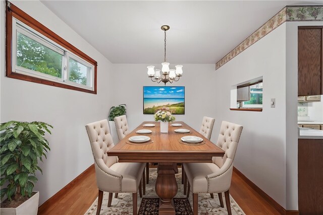 124 Plum St, Franklin Twp, PA 16117 - dining room featuring a chandelier, wood finished floors, plenty of natural light, and baseboards