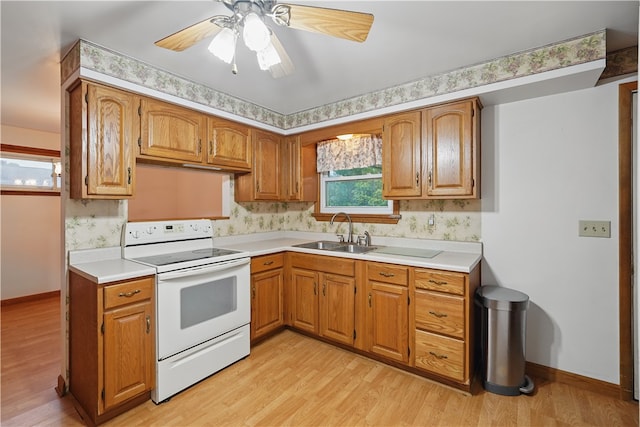 124 Plum St, Franklin Twp, PA 16117 - kitchen featuring white range with electric stovetop, a sink, light wood finished floors, brown cabinetry, and light countertops