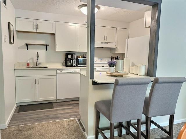 2465 Brook Ledge Rd Unit 31A, South Fayette, PA 15017 - kitchen featuring white appliances, a sink, under cabinet range hood, white cabinets, and light countertops