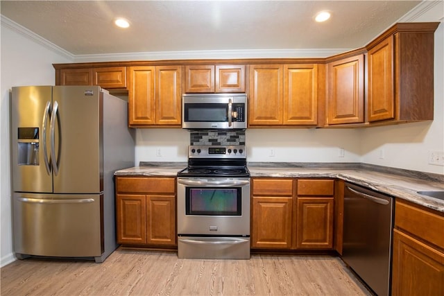 220 Chinkapin Dr, Natrona Hts/Harrison Twp, PA 15065 - kitchen with appliances with stainless steel finishes, brown cabinets, ornamental molding, light wood-style flooring, and recessed lighting
