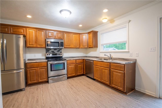 220 Chinkapin Dr, Natrona Hts/Harrison Twp, PA 15065 - kitchen with appliances with stainless steel finishes, brown cabinetry, light wood-style floors, ornamental molding, and recessed lighting
