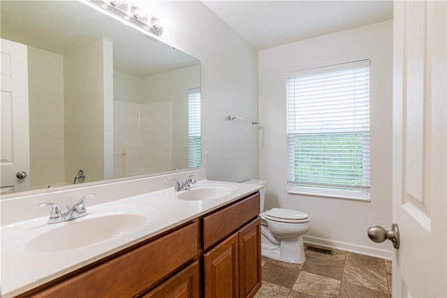 220 Chinkapin Dr, Natrona Hts/Harrison Twp, PA 15065 - bathroom with toilet, double vanity, baseboards, and a shower