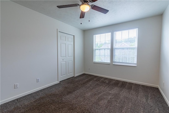 220 Chinkapin Dr, Natrona Hts/Harrison Twp, PA 15065 - unfurnished bedroom featuring dark colored carpet, baseboards, a textured ceiling, ceiling fan, and a closet