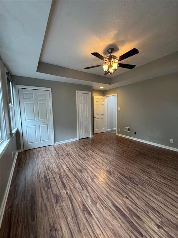 2422 Salisbury St, South Side, PA 15210 - unfurnished bedroom with baseboards, a raised ceiling, and dark wood-style flooring