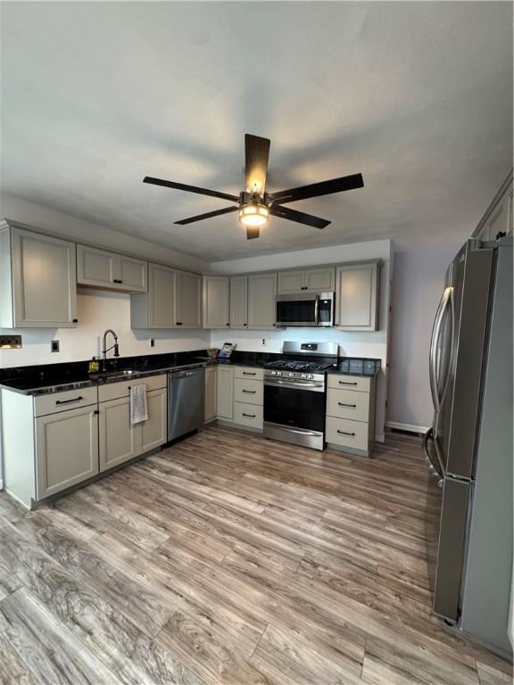 2422 Salisbury St, South Side, PA 15210 - kitchen featuring appliances with stainless steel finishes, gray cabinets, a sink, and dark countertops