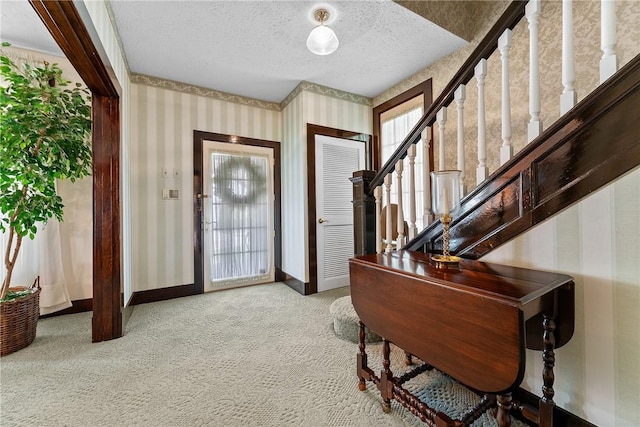 534 N Main St, Masontown, PA 15461 - carpeted foyer entrance with wallpapered walls, a textured ceiling, stairs, and baseboards