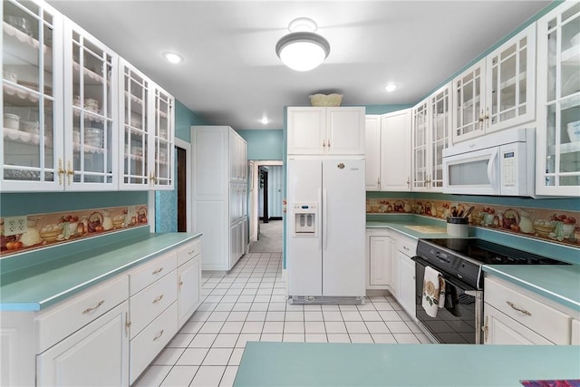 534 N Main St, Masontown, PA 15461 - kitchen with white appliances, white cabinetry, glass insert cabinets, light tile patterned floors, and recessed lighting