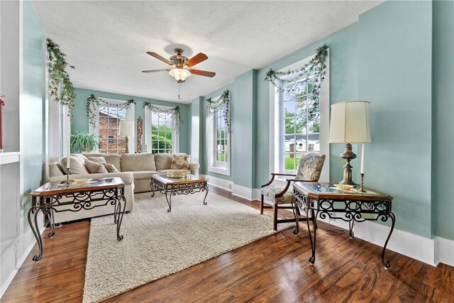 534 N Main St, Masontown, PA 15461 - living area with healthy amount of natural light, a ceiling fan, wood finished floors, a textured ceiling, and baseboards