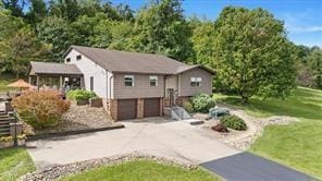 208 Kozy Cor, Middlesex Twp, PA 16059 - split foyer home with a garage, asphalt driveway, and a front yard