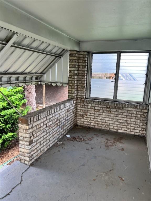 505 Monongahela Ave, Glassport, PA 15045 - unfurnished living room with brick wall and concrete floors