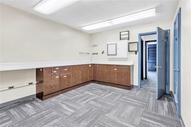 144 S 20th St, South Side, PA 15203 - kitchen with carpet flooring, brown cabinetry, light countertops, and baseboards