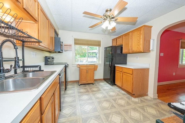 117 Derby Way, Aliquippa, PA 15001 - kitchen with black appliances, a sink, arched walkways, and light countertops