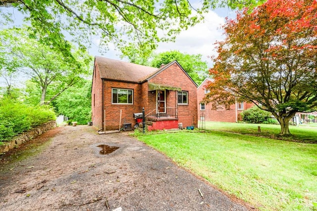117 Derby Way, Aliquippa, PA 15001 - bungalow-style house with brick siding, a front yard, and driveway