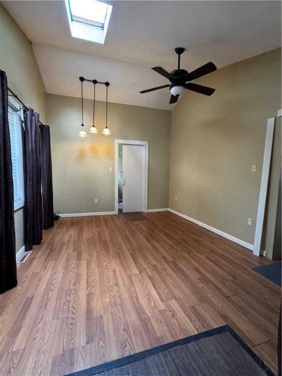 29 Old Mine Rd, Center Twp/Homer Cty, PA 15748 - spare room featuring a skylight, wood finished floors, baseboards, ceiling fan, and vaulted ceiling