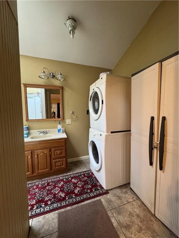 29 Old Mine Rd, Center Twp/Homer Cty, PA 15748 - laundry area with estacked washer and dryer, light tile patterned flooring, and baseboards