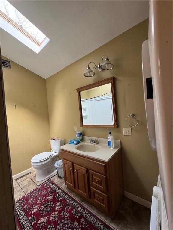 29 Old Mine Rd, Center Twp/Homer Cty, PA 15748 - bathroom featuring toilet, vanity, a skylight, baseboards, and tile patterned flooring