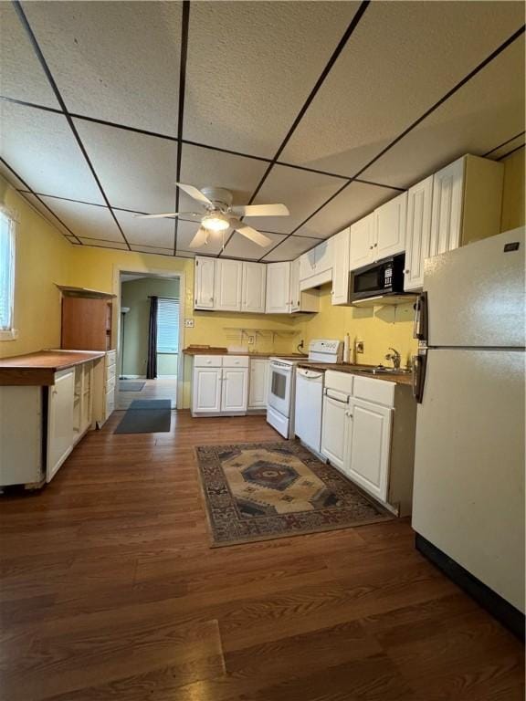 29 Old Mine Rd, Center Twp/Homer Cty, PA 15748 - kitchen featuring white appliances, a drop ceiling, a sink, white cabinets, and dark wood-style flooring