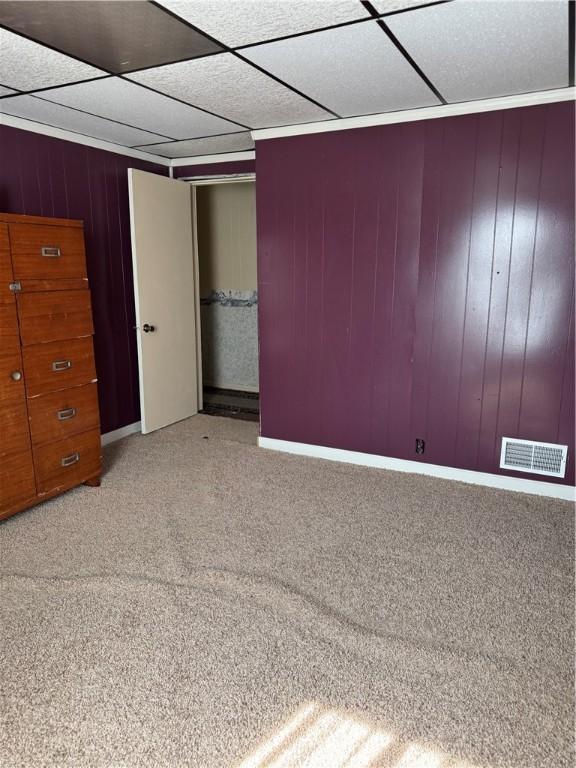 29 Old Mine Rd, Center Twp/Homer Cty, PA 15748 - unfurnished bedroom featuring light colored carpet, a drop ceiling, and wood walls