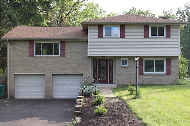 1502 Orchard Dr, Unity Twp, PA 15601 - tri-level home featuring an attached garage, asphalt driveway, a front lawn, and brick siding