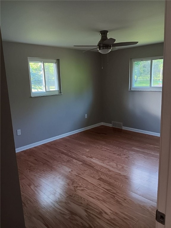 1502 Orchard Dr, Unity Twp, PA 15601 - empty room featuring healthy amount of natural light, wood finished floors, and baseboards