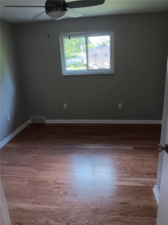 1502 Orchard Dr, Unity Twp, PA 15601 - unfurnished room featuring ceiling fan, wood finished floors, and baseboards