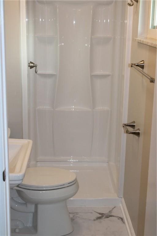 1502 Orchard Dr, Unity Twp, PA 15601 - bathroom featuring toilet, marble finish floors, a shower, and baseboards