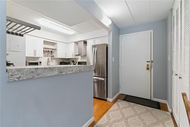 5 Bayard Rd Unit 206, Shadyside, PA 15213 - kitchen with stainless steel appliances, wall chimney exhaust hood, light countertops, and white cabinets