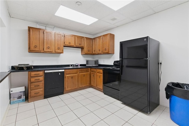 5 Bayard Rd Unit 206, Shadyside, PA 15213 - kitchen with black appliances, dark countertops, a paneled ceiling, and brown cabinetry