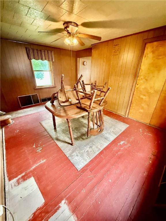 411 E Ave, Luzerne Twp, PA 15413 - dining area with ceiling fan, wooden walls, and wood finished floors
