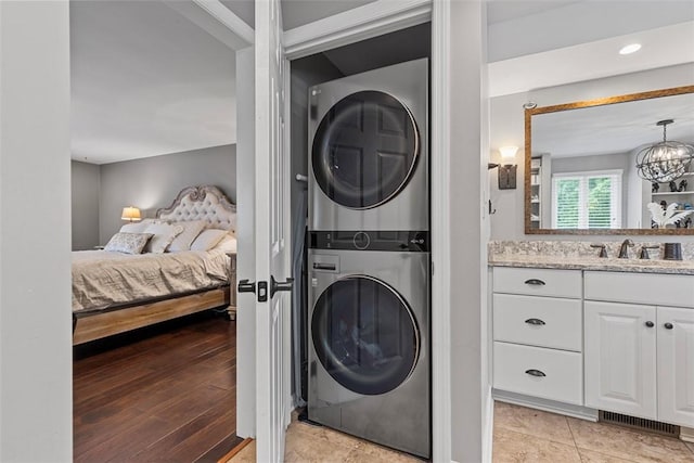 152 Devonwood Dr, Upper St Clair, PA 15241 - laundry room featuring estacked washer and dryer and a chandelier