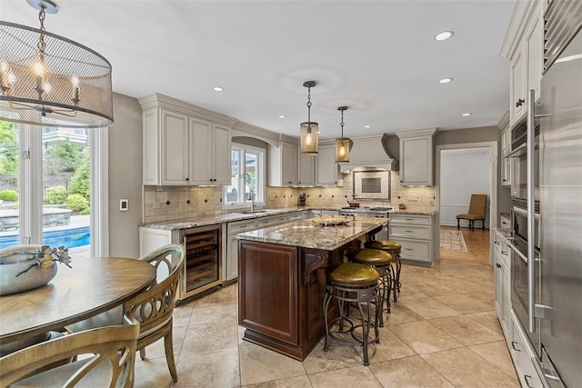 152 Devonwood Dr, Upper St Clair, PA 15241 - kitchen featuring wine cooler, a sink, backsplash, a kitchen island, and custom range hood