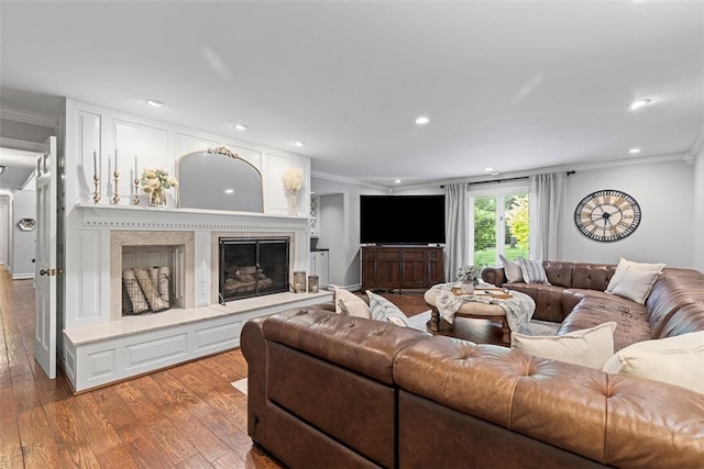 152 Devonwood Dr, Upper St Clair, PA 15241 - living area with crown molding, wood finished floors, recessed lighting, and a fireplace with raised hearth