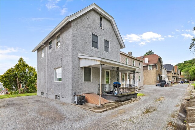 545 Ohio Ave, Midland Boro, PA 15059 - view of front of house featuring a porch, central AC, stucco siding, and a residential view
