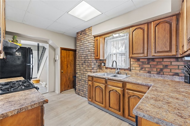 545 Ohio Ave, Midland Boro, PA 15059 - kitchen with a sink, black appliances, brown cabinetry, and a drop ceiling